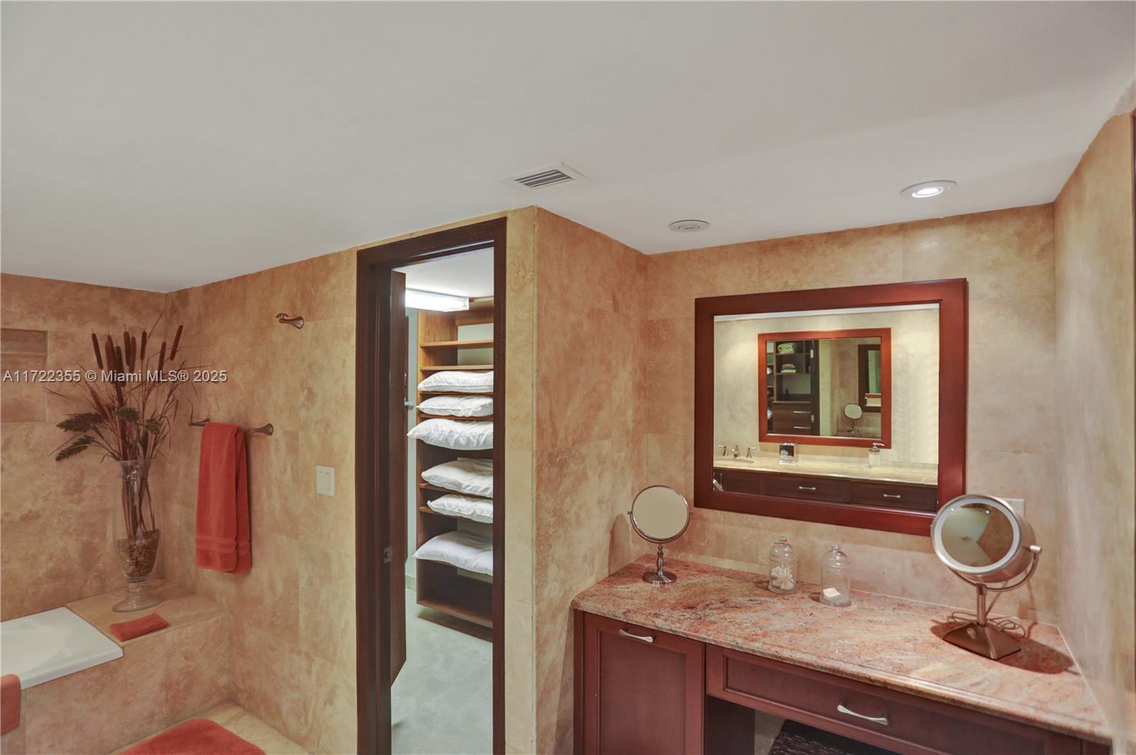 1121 Crandon Boulevard, Unit E405 Key Biscayne, FL 33149 - Photo 10 of 32 a bathroom with a granite countertop sink and a mirror