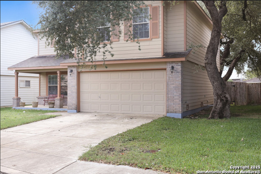 3954 Regal Rose San Antonio, TX 78259 - Photo 2 of 18 a front view of a house with a garden and yard