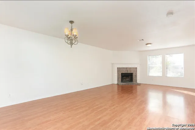 a view of a room with window and ceiling fan