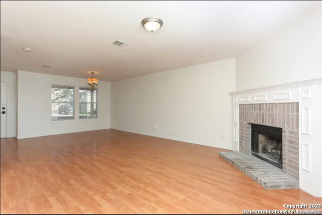 a view of empty room with fireplace
