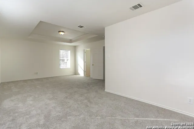 a view of an empty room with windows