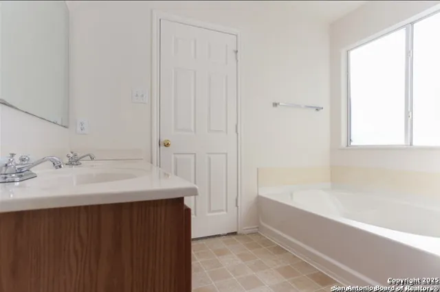 a bathroom with a bathtub and a sink