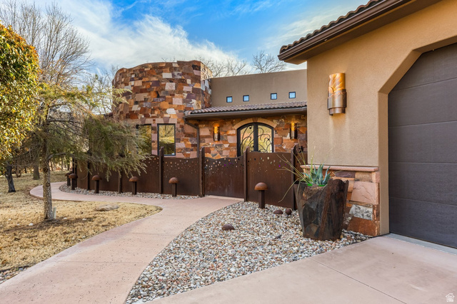 98 Bridge Road Rockville, UT 84763 - Photo 63 of 75 Doorway to property with a tile roof, stucco siding, stone siding, and a garage