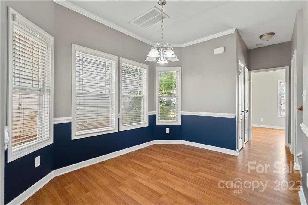 12320 Cross Meadow Road Huntersville, NC 28078 - Photo 5 of 17 a bedroom with a large bed chandelier and a window