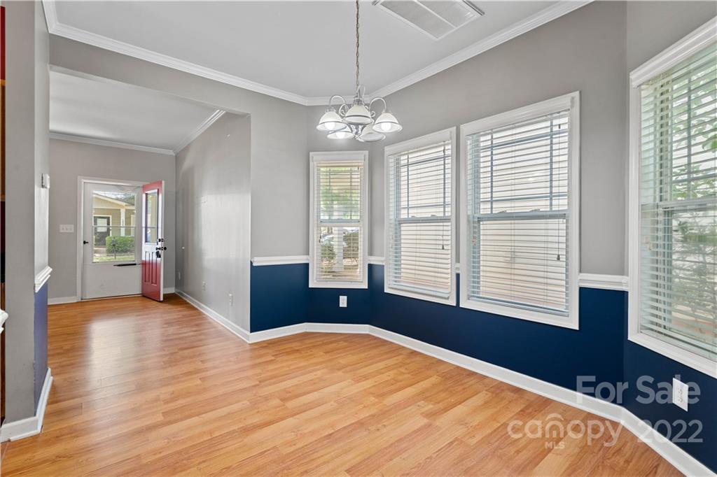 12320 Cross Meadow Road Huntersville, NC 28078 - Photo 6 of 17 a bedroom with a bed and a chandelier