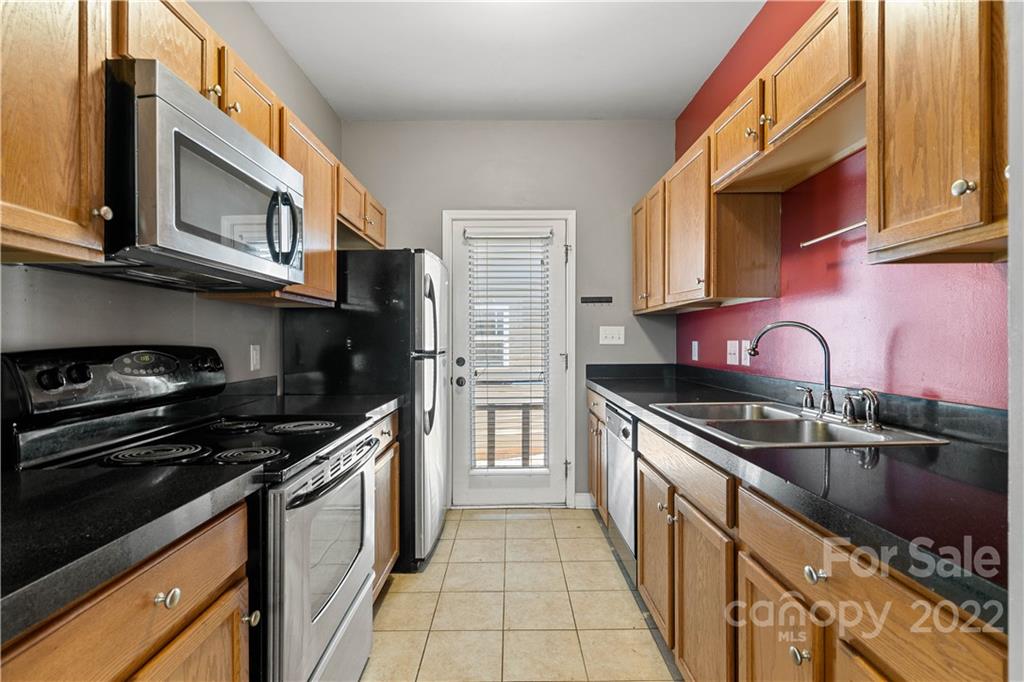 12320 Cross Meadow Road Huntersville, NC 28078 - Photo 7 of 17 a kitchen with stainless steel appliances granite countertop a stove a sink and a microwave