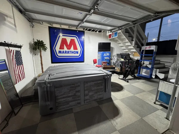 a view of a swimming pool with a cars parked on the road