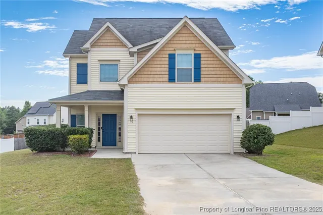 a front view of a house with a yard