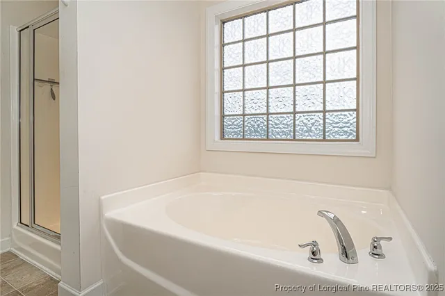 a white bath tub sitting next to a window