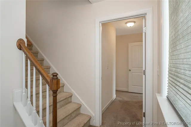 a view of a hallway with wooden floor and entryway