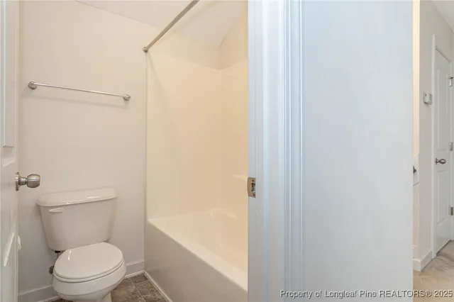 a white toilet sitting next to a bathroom sink