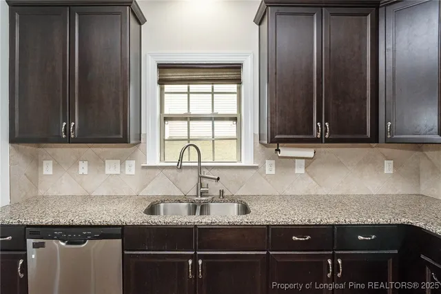 a kitchen with granite countertop a sink and a cabinets