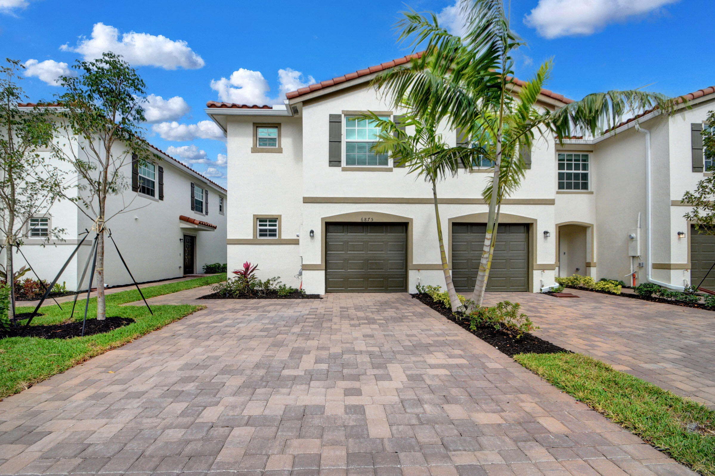 6875 Broadwater Ln Lake Lake Worth, FL 33467 - Photo 1 of 20 a front view of a house with a yard and a garage