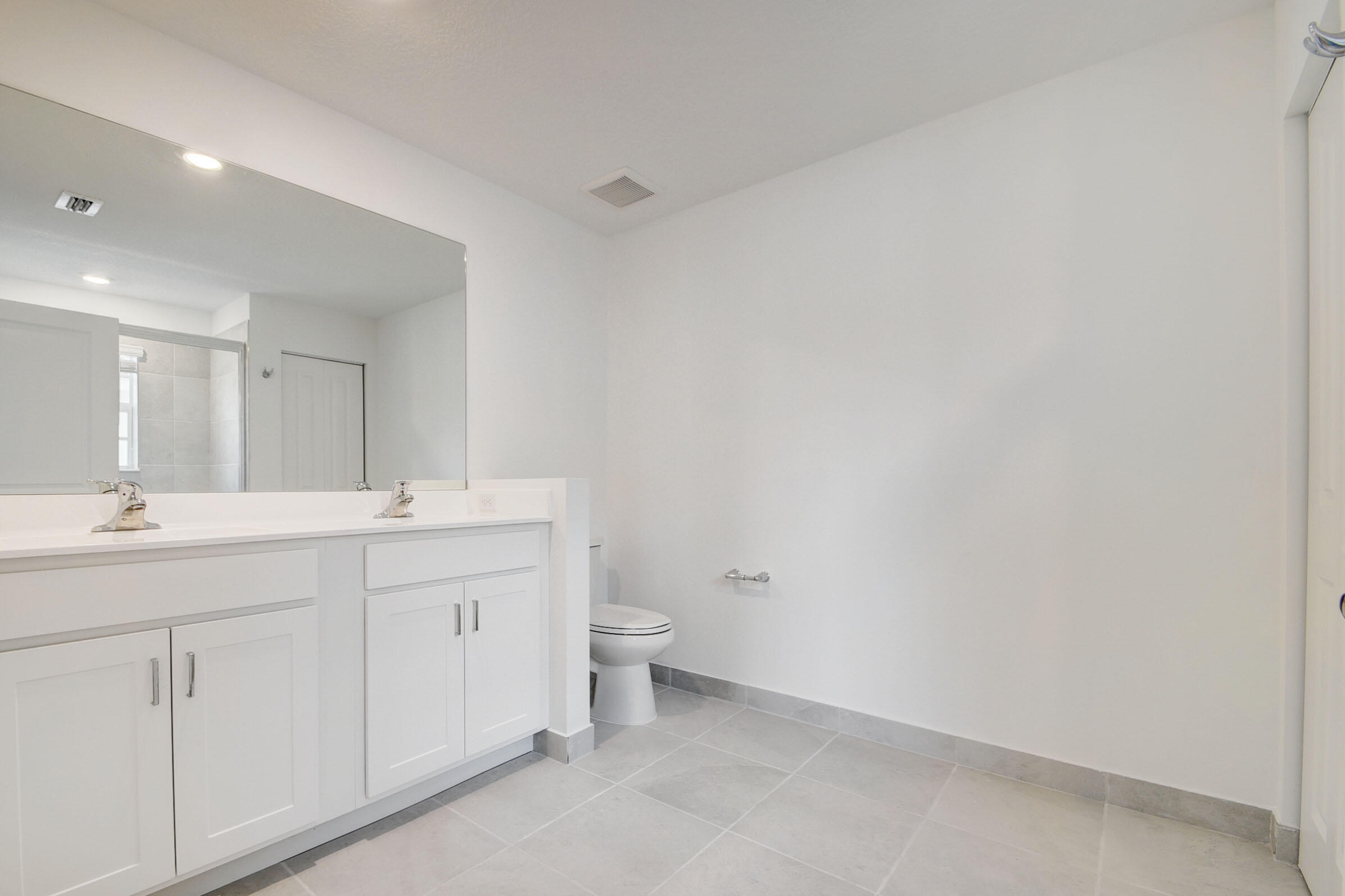6875 Broadwater Ln Lake Lake Worth, FL 33467 - Photo 14 of 20 a bathroom with a double vanity sink and a toilet