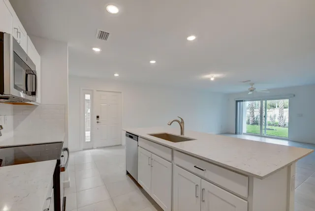 a kitchen with a sink and a refrigerator