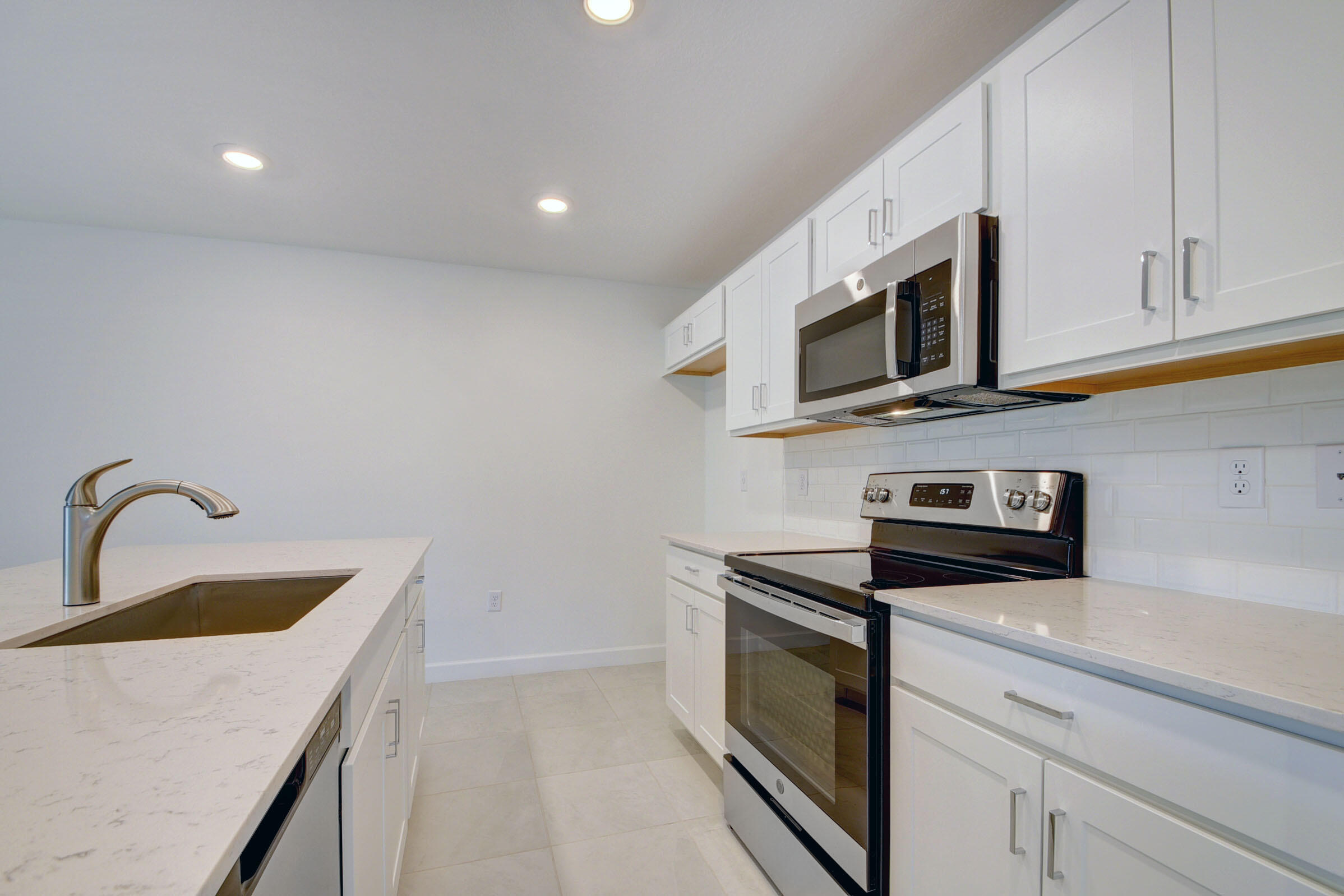 6875 Broadwater Ln Lake Lake Worth, FL 33467 - Photo 3 of 20 a kitchen with stainless steel appliances granite countertop a sink a stove microwave and refrigerator