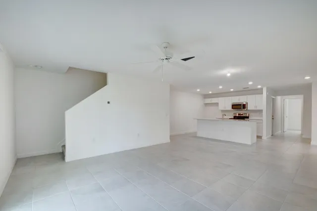 a view of a kitchen with a sink and a refrigerator
