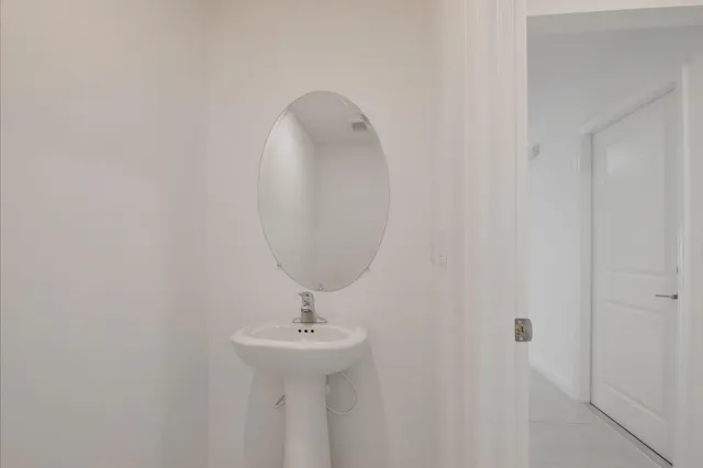 a bathroom with a sink and mirror