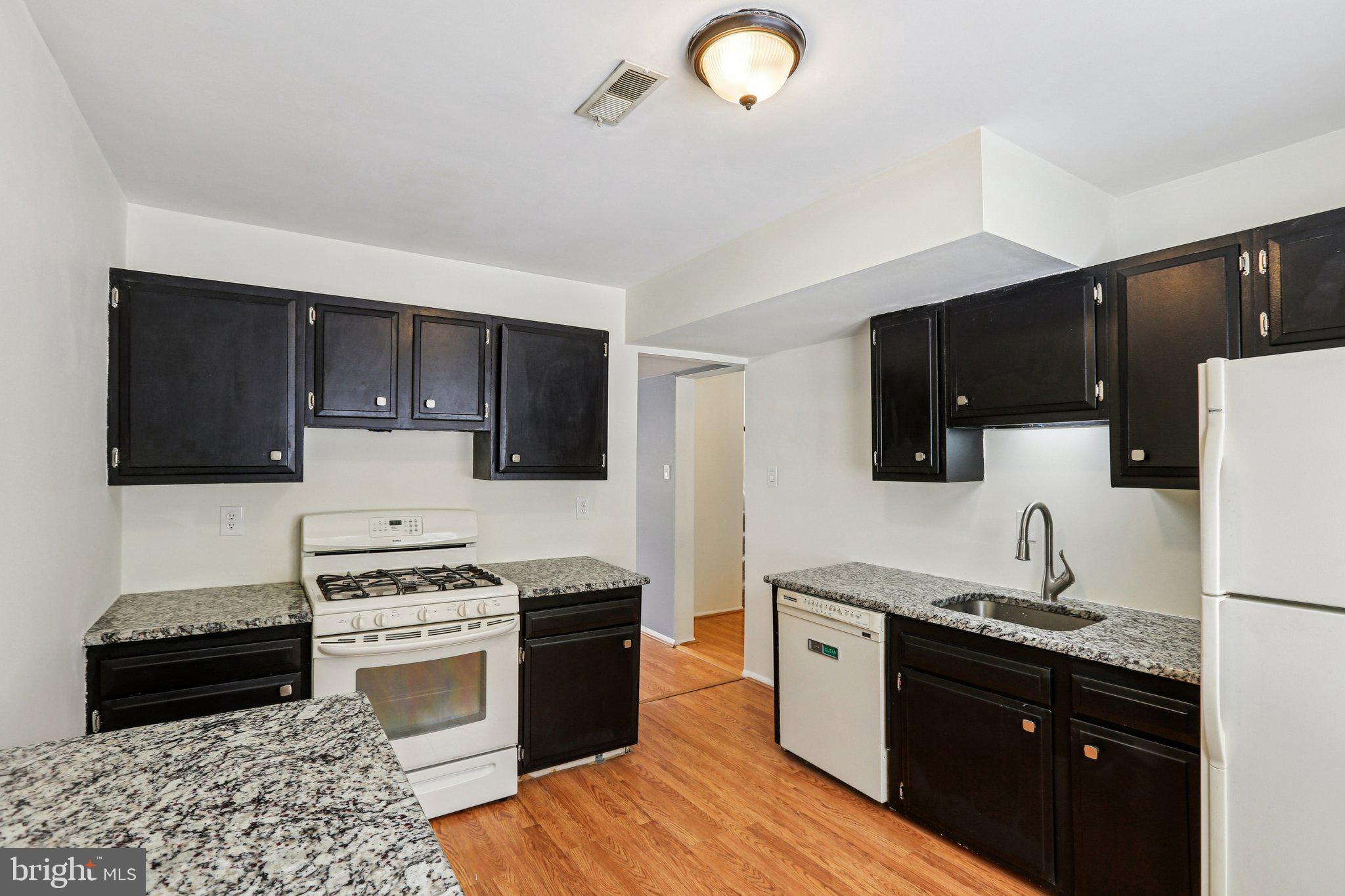 117 West Village Road Elkton, MD 21921 - Photo 7 of 37 a kitchen with a sink stove and microwave