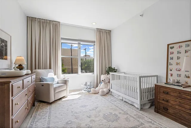 a spacious bedroom with a bed and a large window