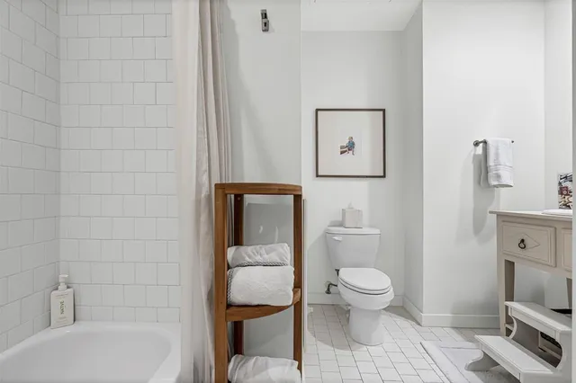 a bathroom with a toilet and a bathtub