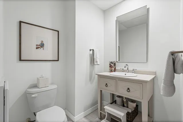a bathroom with a toilet a sink and mirror