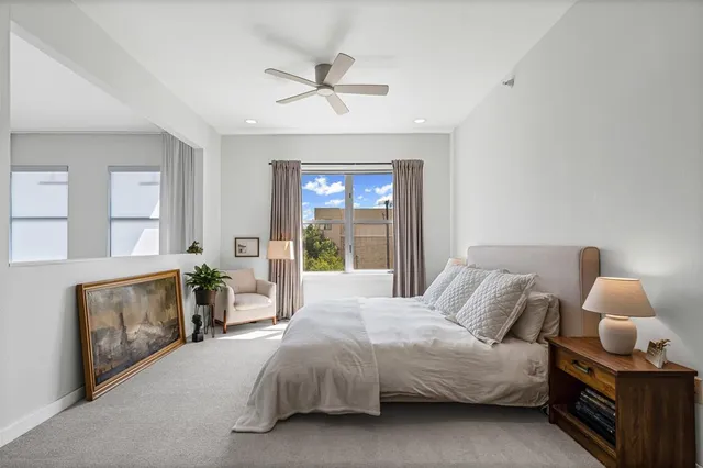 a spacious bedroom with a bed and a window