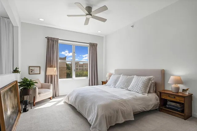 a bedroom with a large bed and a window