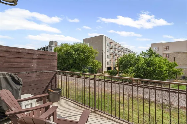 a view of a balcony with two chairs and a potted plant