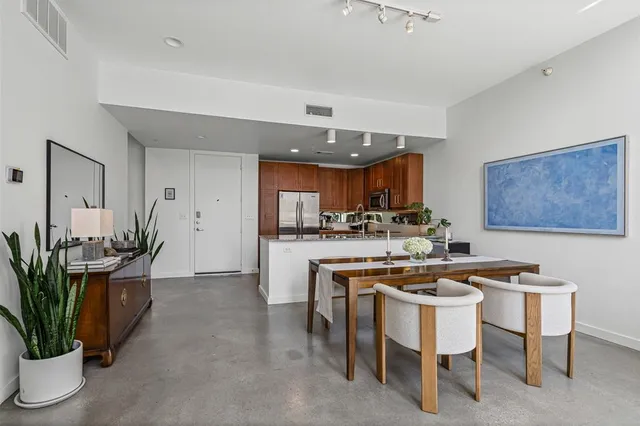 a kitchen with kitchen island a table and chairs in it
