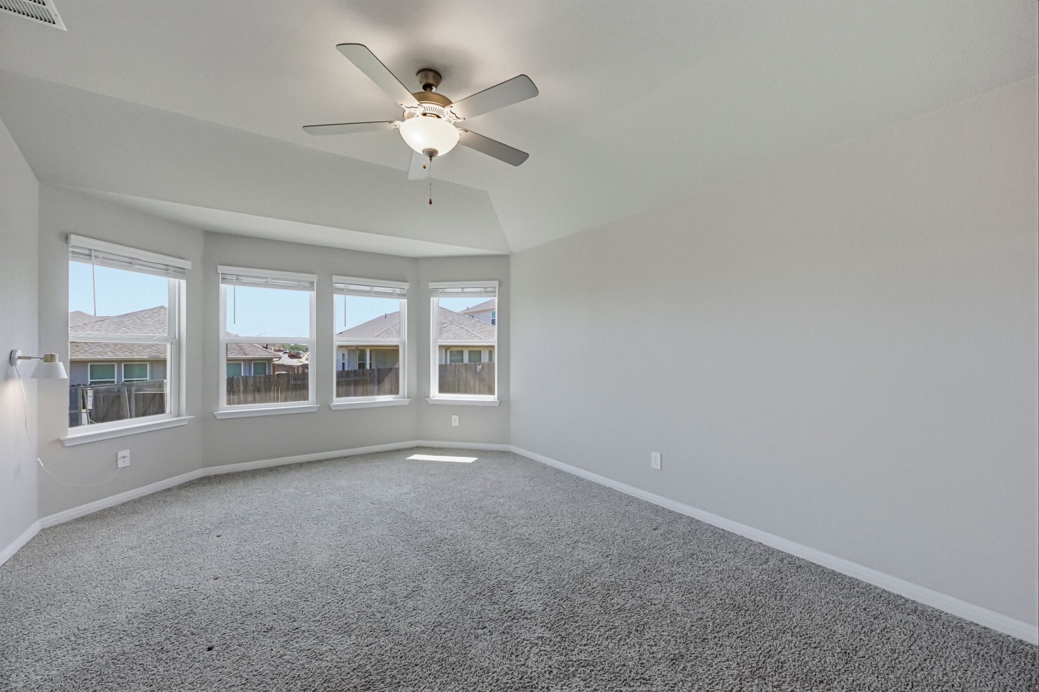 12309 Dairywork Road Buda, TX 78610 - Photo 11 of 29 Carpeted spare room with a ceiling fan and lofted ceiling