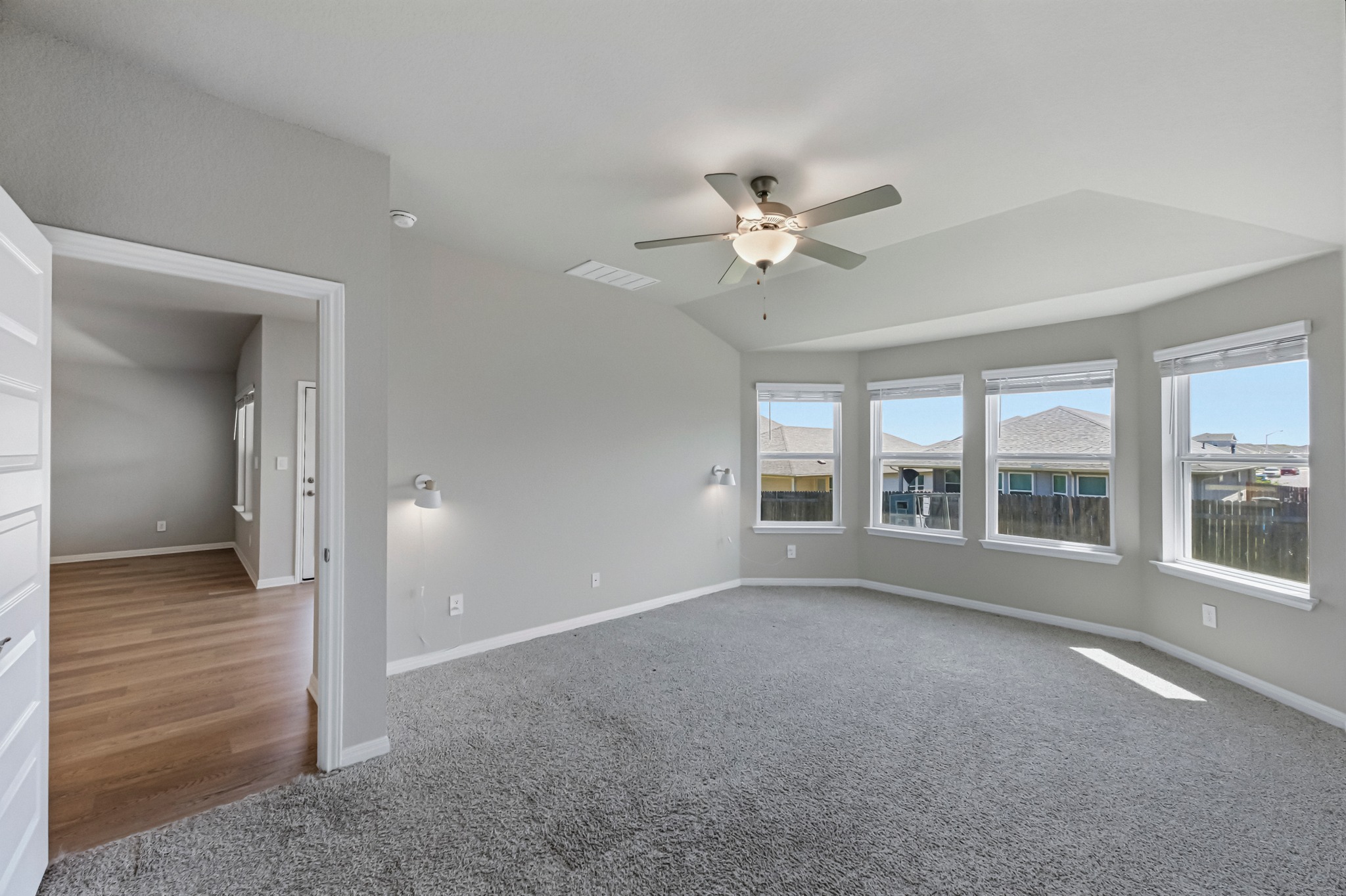 12309 Dairywork Road Buda, TX 78610 - Photo 12 of 29 Spare room featuring light colored carpet, a ceiling fan, and lofted ceiling