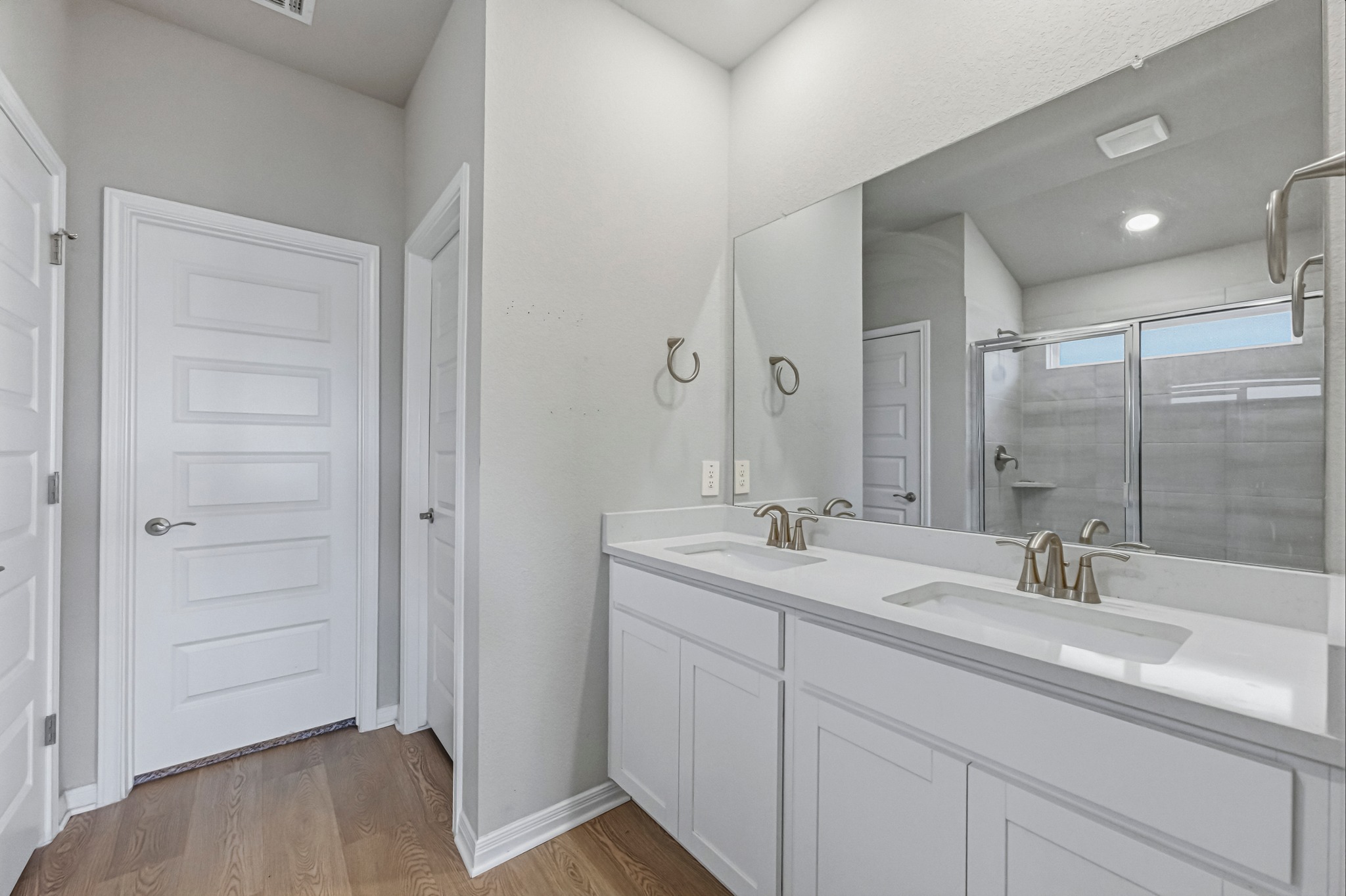 12309 Dairywork Road Buda, TX 78610 - Photo 14 of 29 Full bath with double vanity, light wood-type flooring, a stall shower, and recessed lighting