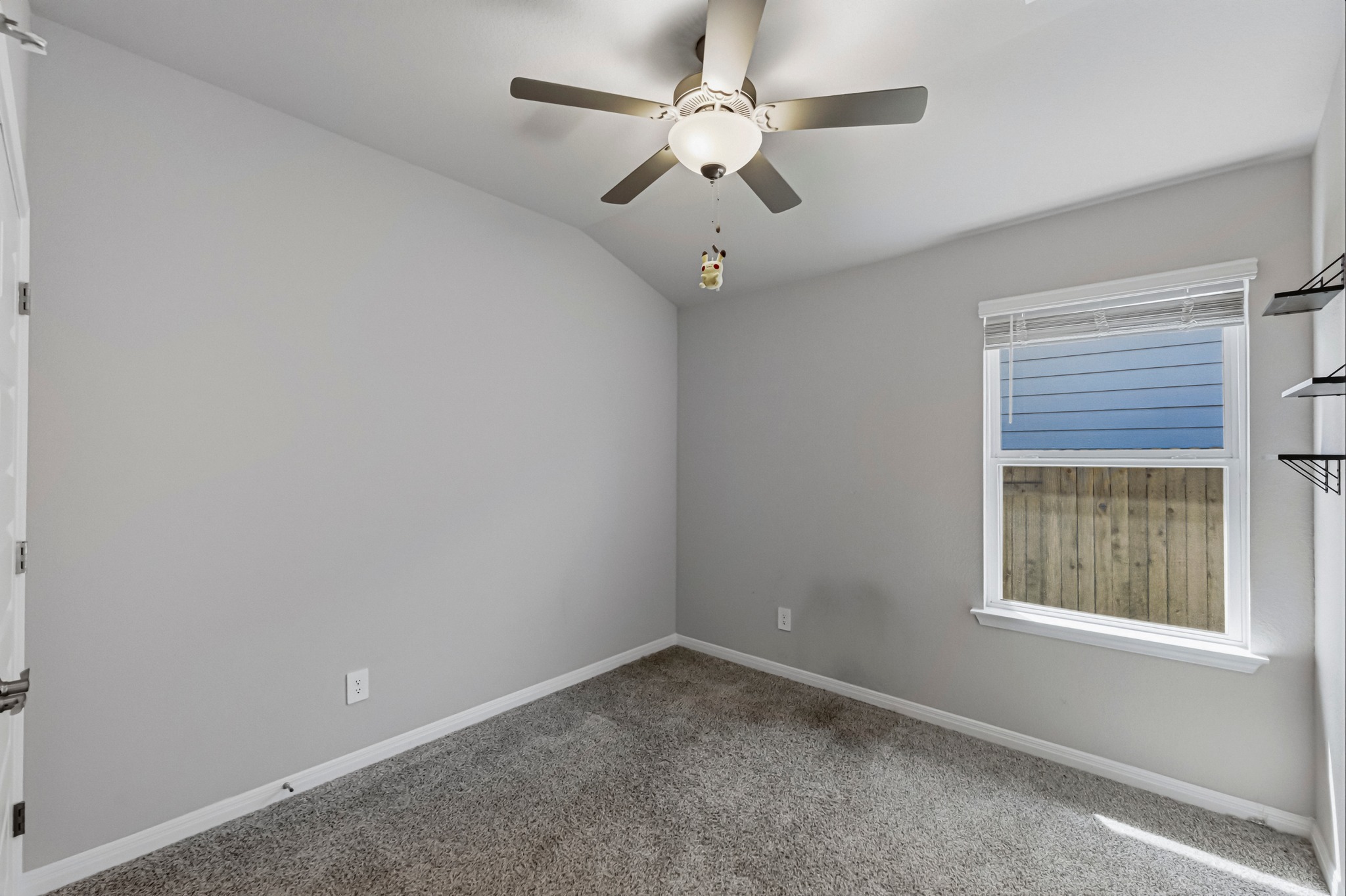 12309 Dairywork Road Buda, TX 78610 - Photo 17 of 29 Carpeted empty room with a ceiling fan and vaulted ceiling