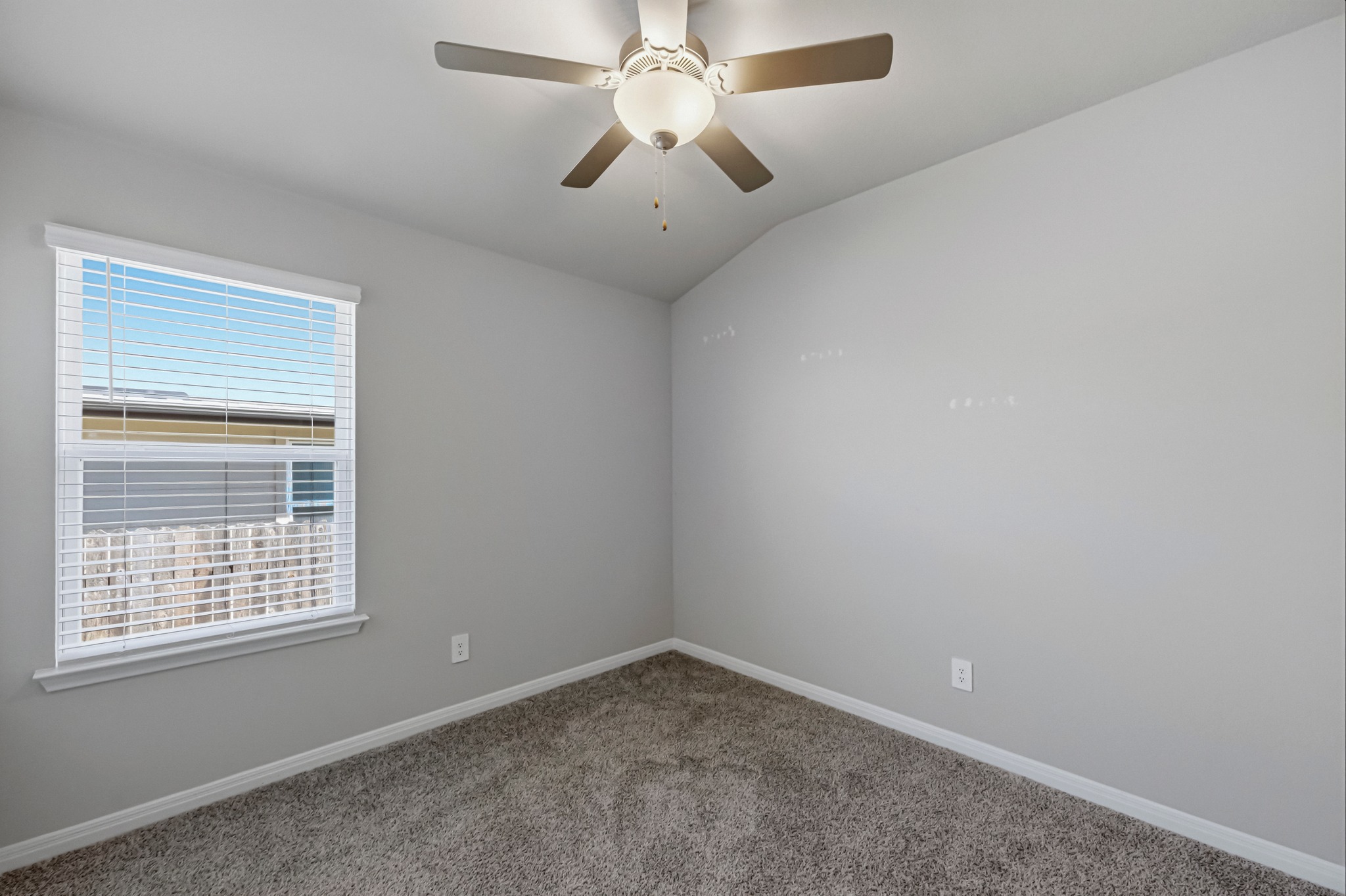 12309 Dairywork Road Buda, TX 78610 - Photo 18 of 29 Unfurnished room with vaulted ceiling, carpet floors, and a ceiling fan