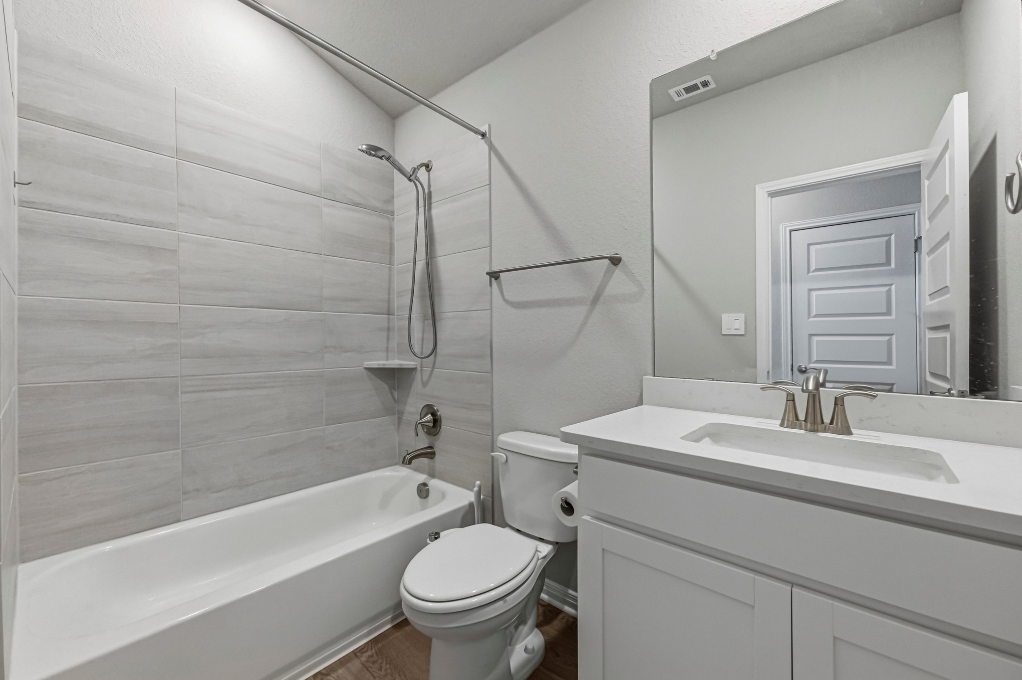12309 Dairywork Road Buda, TX 78610 - Photo 19 of 29 Bathroom with vanity, shower / washtub combination, and dark wood-type flooring