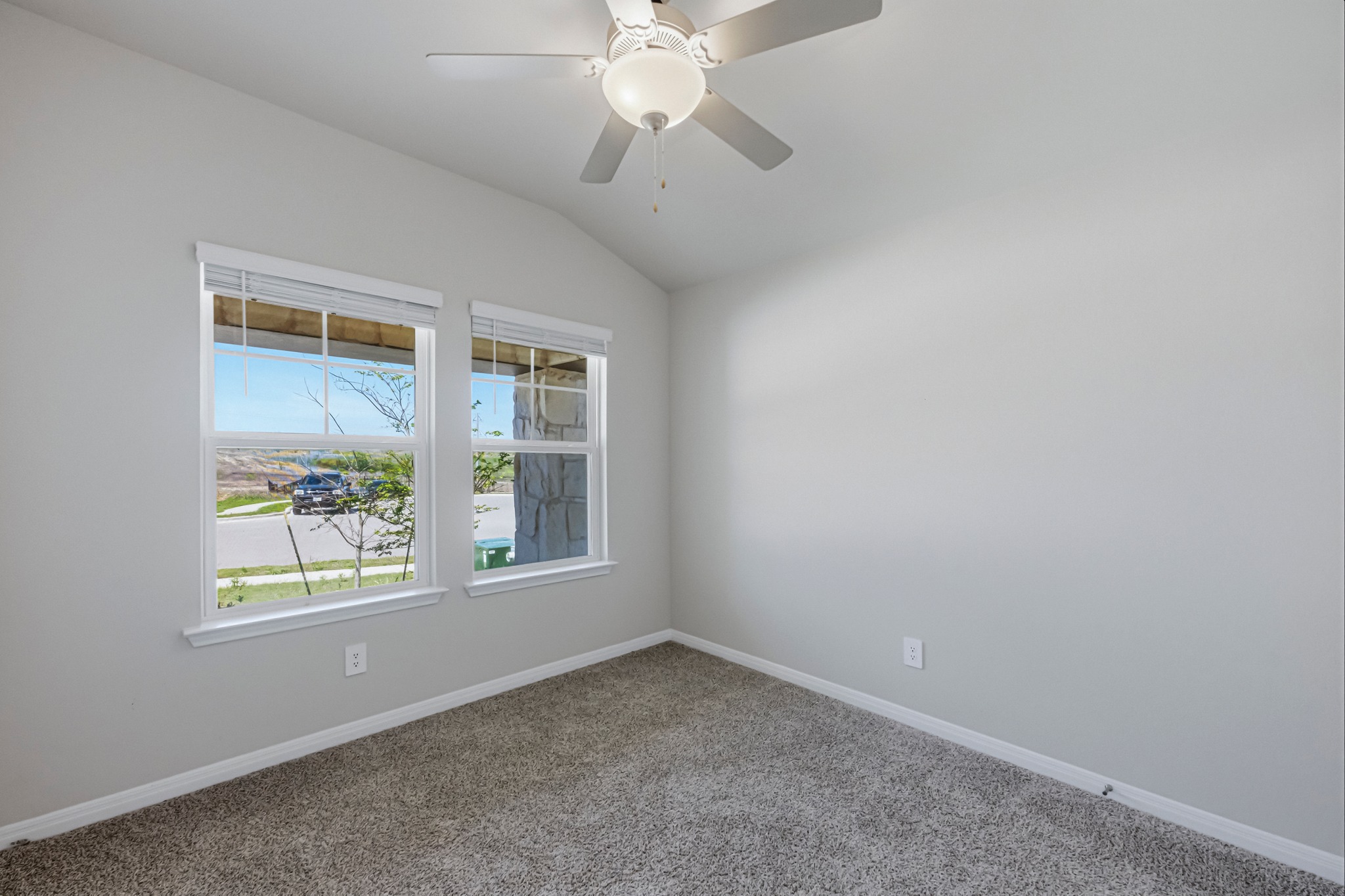 12309 Dairywork Road Buda, TX 78610 - Photo 20 of 29 Carpeted spare room featuring lofted ceiling and ceiling fan