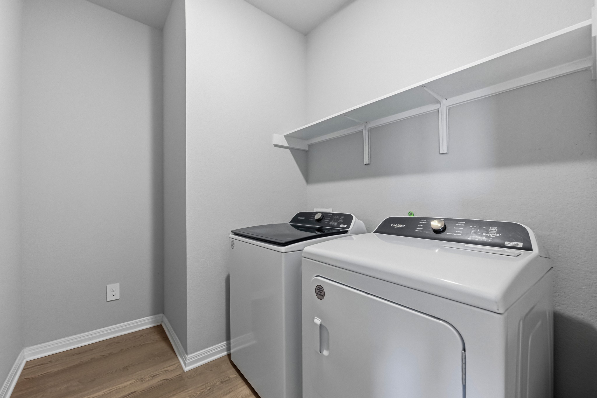 12309 Dairywork Road Buda, TX 78610 - Photo 21 of 29 Laundry area with light wood-style floors and washing machine and dryer