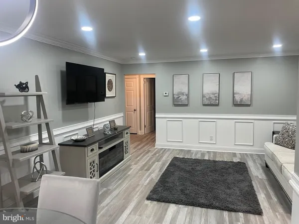 a kitchen with granite countertop a stove and a flat screen tv
