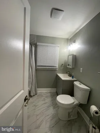 a bathroom with a toilet sink and shower