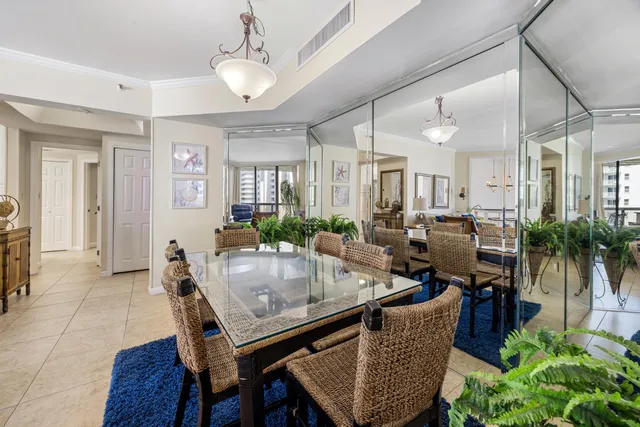 a living room with furniture potted plant and a chandelier