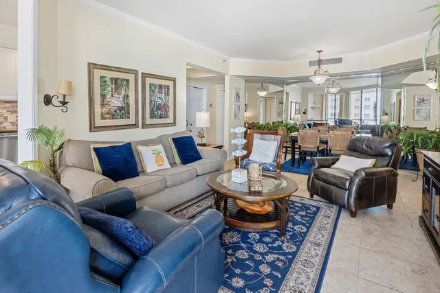 a living room with furniture and a dining room