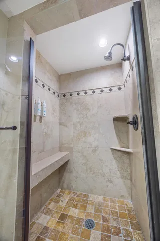 a bathroom with a glass door shower