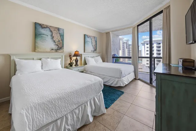 a spacious bedroom with two beds and a large window