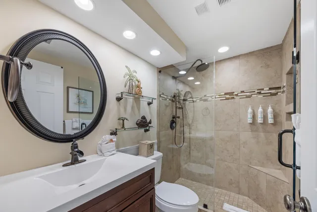 a bathroom with a sink a toilet and a mirror