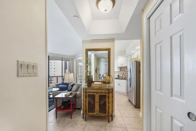 a room with chandelier furniture and large windows
