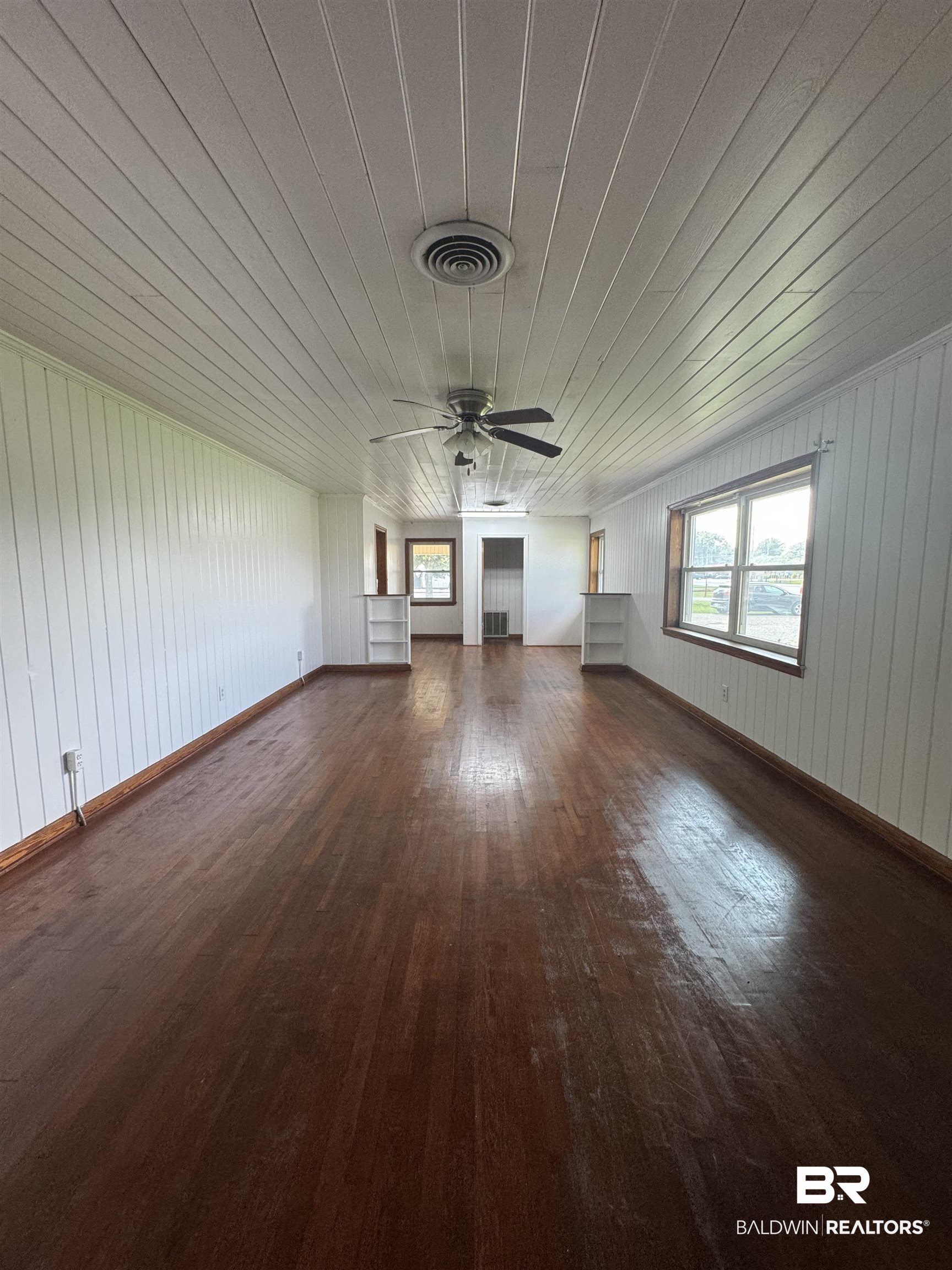 22720 Highway 31 Flomaton, AL 36441 - Photo 11 of 22 Unfurnished living room with wood ceiling, ceiling fan, dark hardwood / wood-style flooring, and wooden walls
