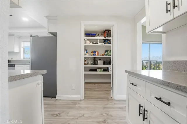 a kitchen with a refrigerator and a sink