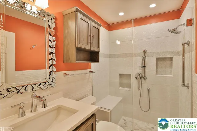 a view of a livingroom with wooden floor and a ceiling fan