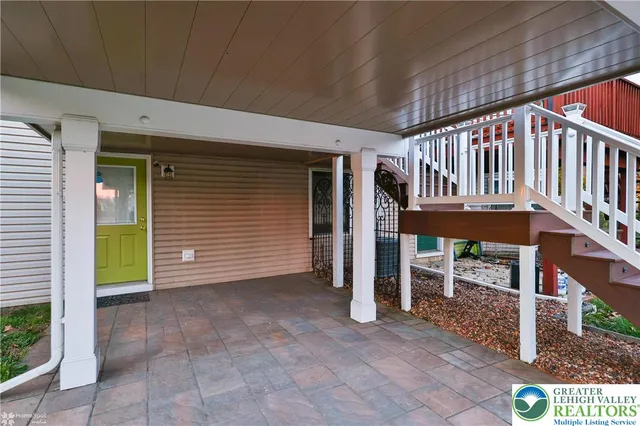 a view of balcony with wooden floor and fence and a couple of benches